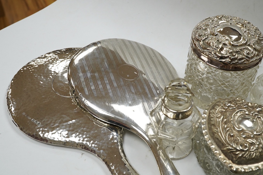 Two silver mounted hand mirrors and a collection of seventeen assorted silver mounted toilet jars. Condition - poor to fair